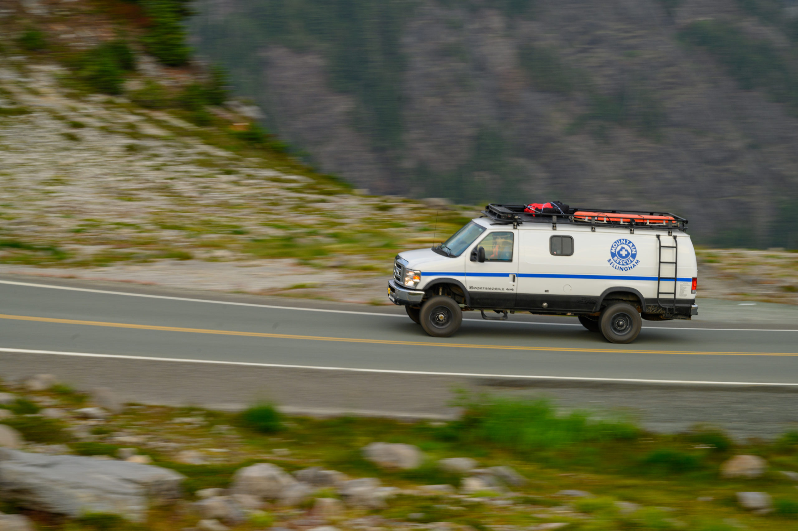 Search and Rescue vehicle travels at speed up a mountain highway